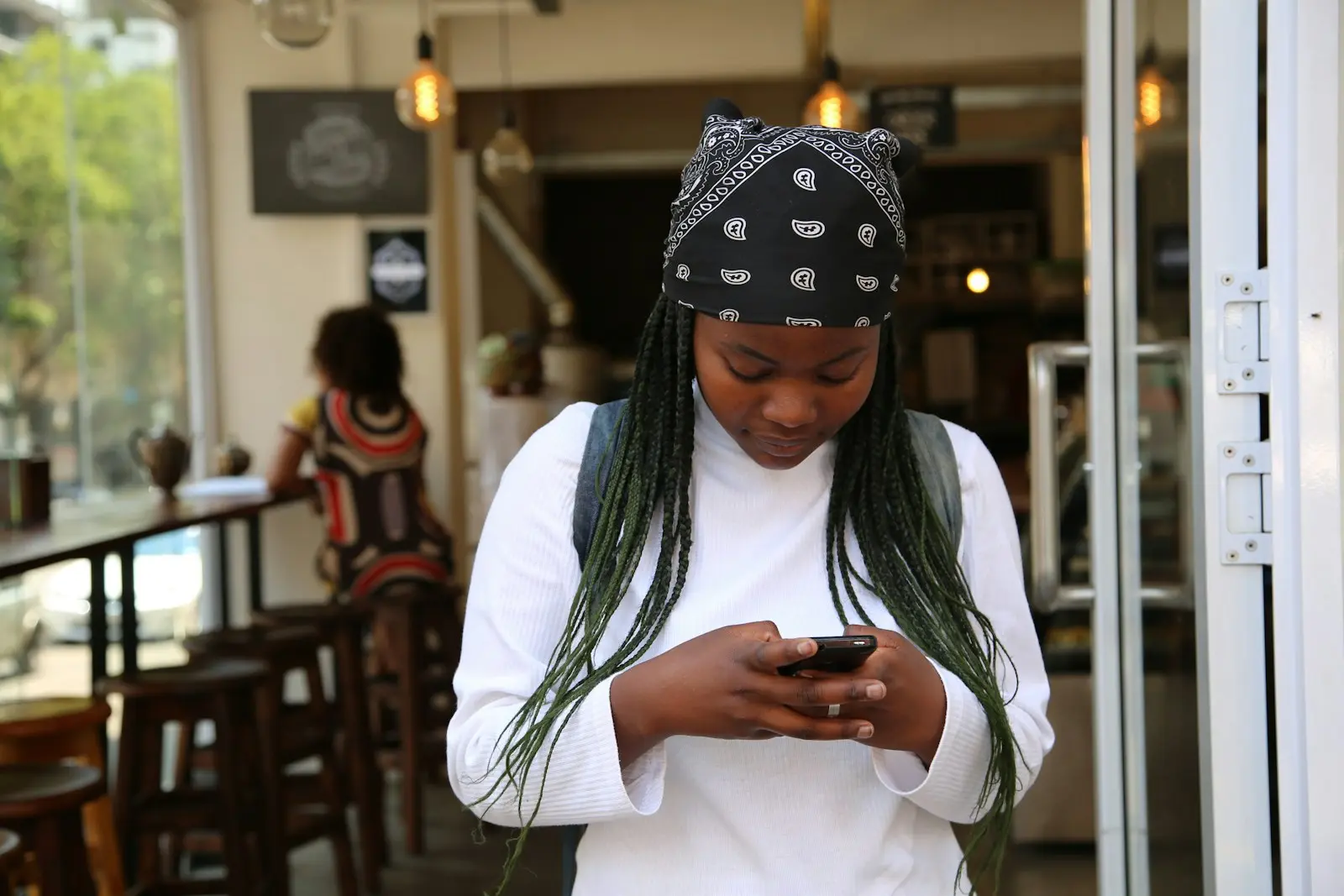 Young woman checking her phone in a café